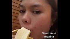 Asian girl sucking banana for fun Thumb