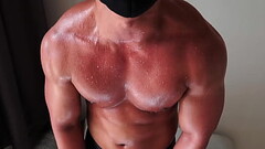 Oiled muscle flexing sweat out Thumb