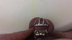 It is a terribly hard thing to pee wearing the small chastity cage at the uncut penis. Another video Thumb